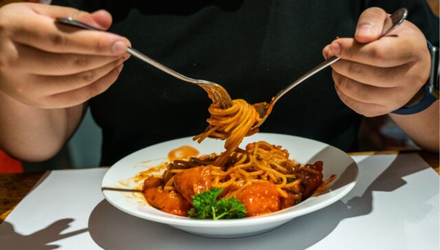 comer macarrão com colher e garfo